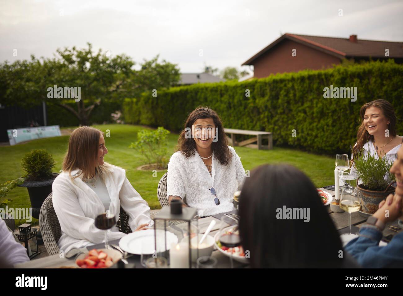 Friends having meal in garden Stock Photo