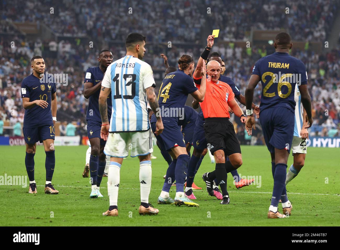 Lusail City, Qatar. 18th Dec, 2022. Marcus Thuram (R) of France is shown the yellow card by referee Szymon Marciniak during the 2022 FIFA World Cup Final at Lusail Stadium in Lusail City, Qatar on December 18, 2022. Photo by Chris Brunskill/UPI Credit: UPI/Alamy Live News Stock Photo
