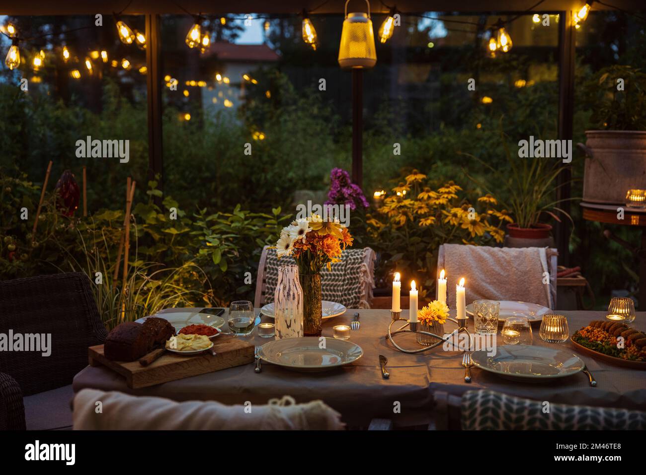 Table set in greenhouse Stock Photo