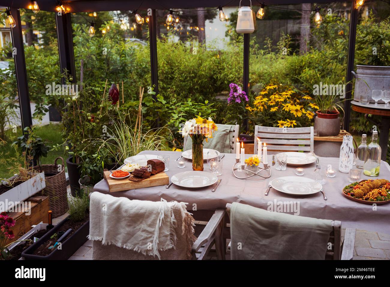 Table set in greenhouse Stock Photo