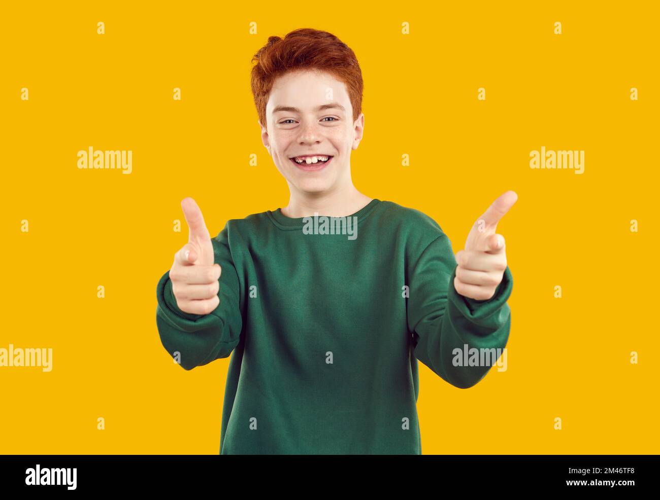 Portrait of happy, toothless, red-haired confident teenager in casual, warm, green sweater. Stock Photo