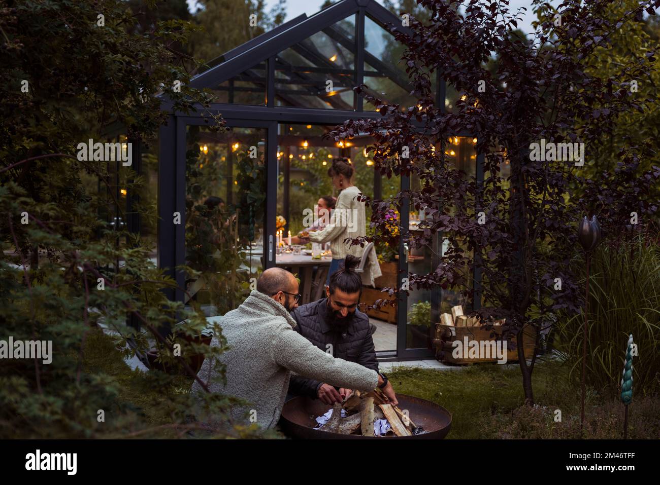 Friends talking in garden Stock Photo