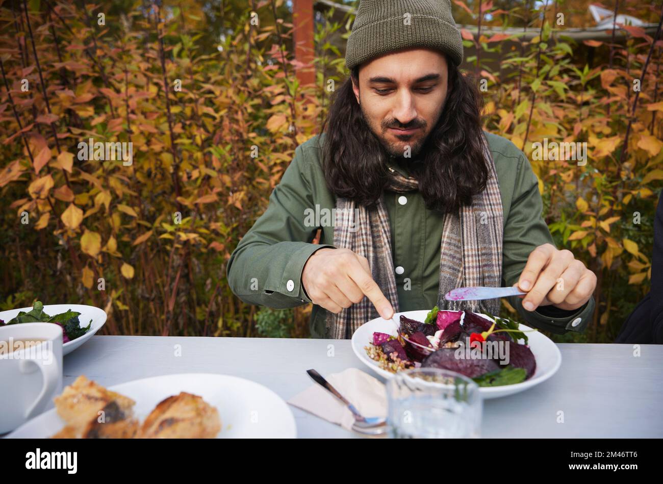 Man eating outdoors Stock Photo