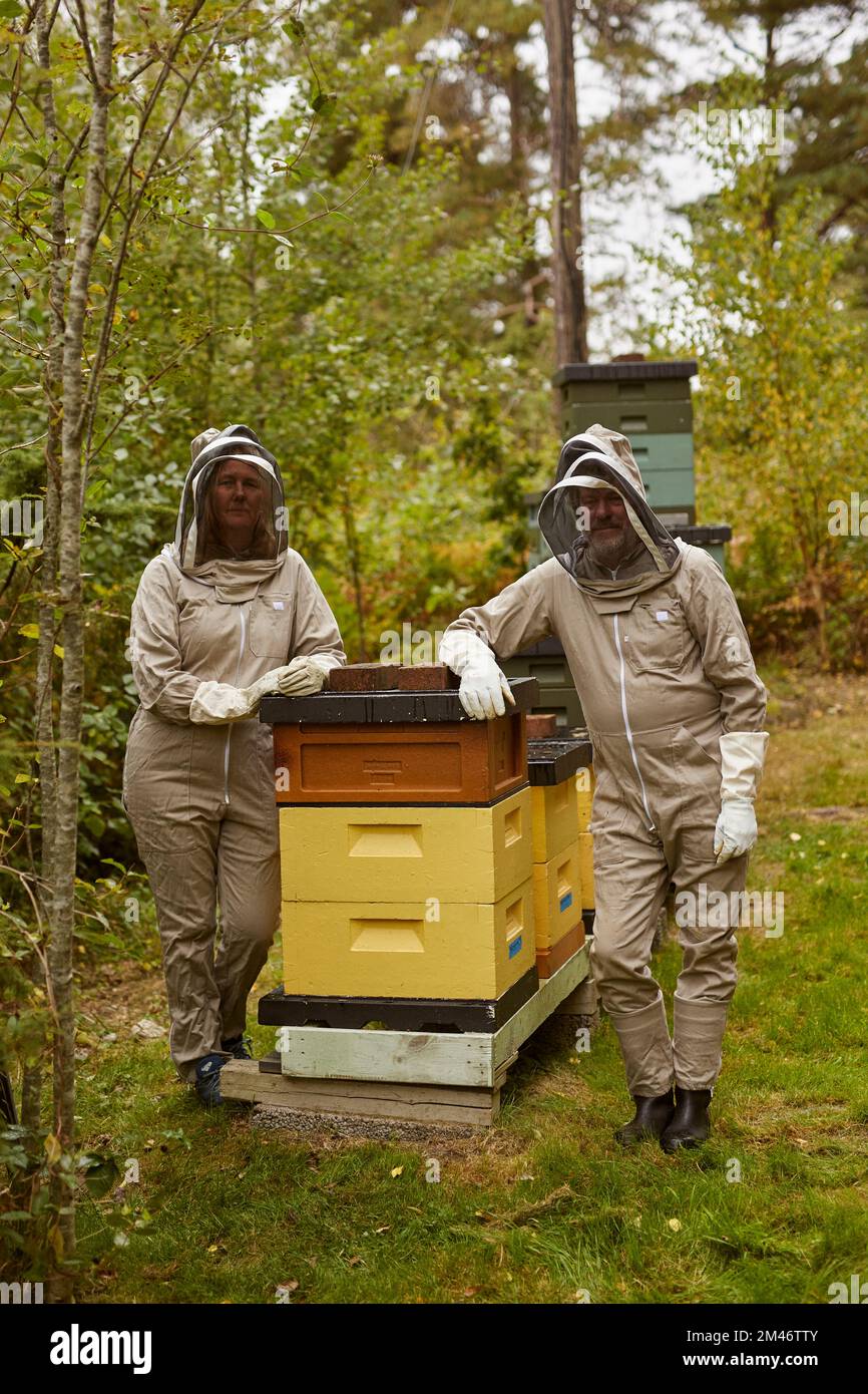 Bee-keepers posing during work Stock Photo - Alamy