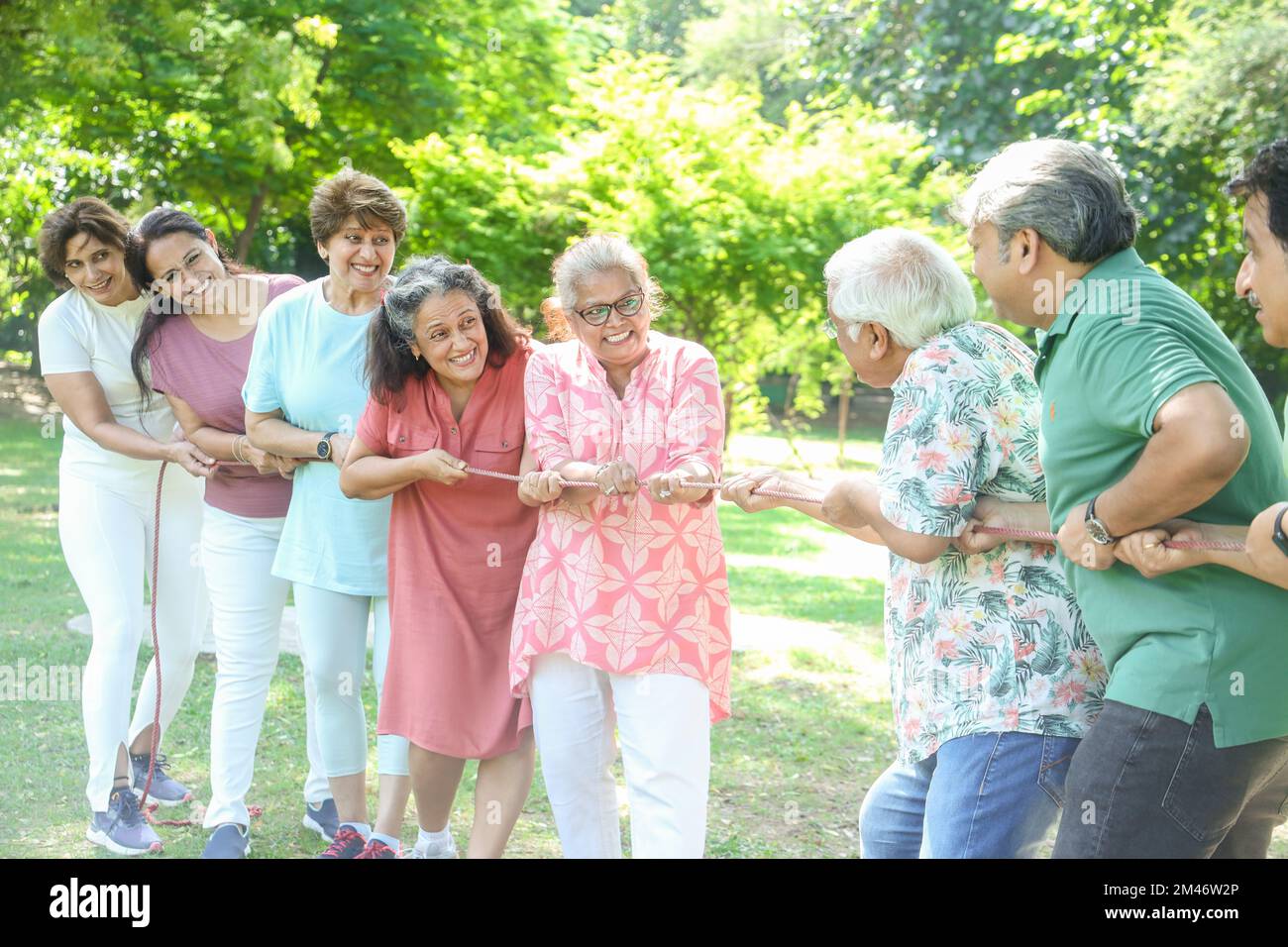 Group Of Senior Indian People Playing Tug War Outdoor In Park. Retirement life. Stock Photo