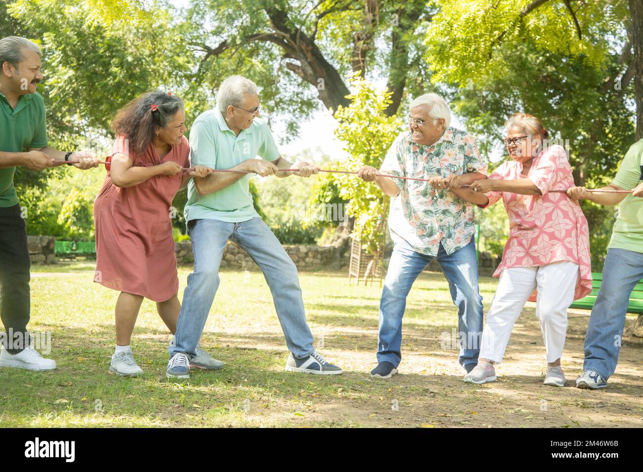 Group Of Senior Indian People Playing Tug War Outdoor In Park. Retirement life. Stock Photo