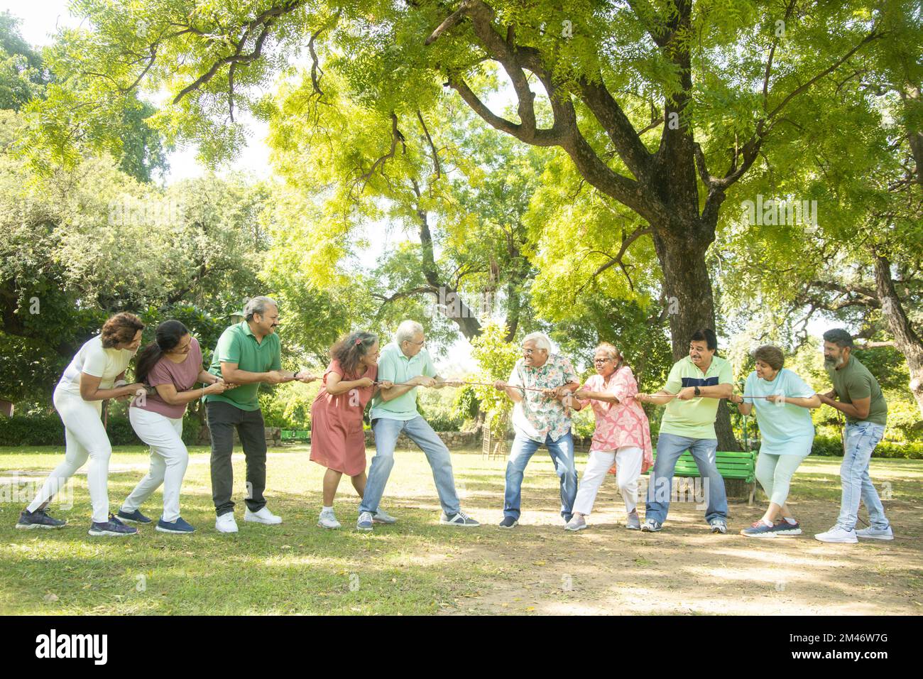 Group Of Senior Indian People Playing Tug War Outdoor In Park. Retirement life. Stock Photo