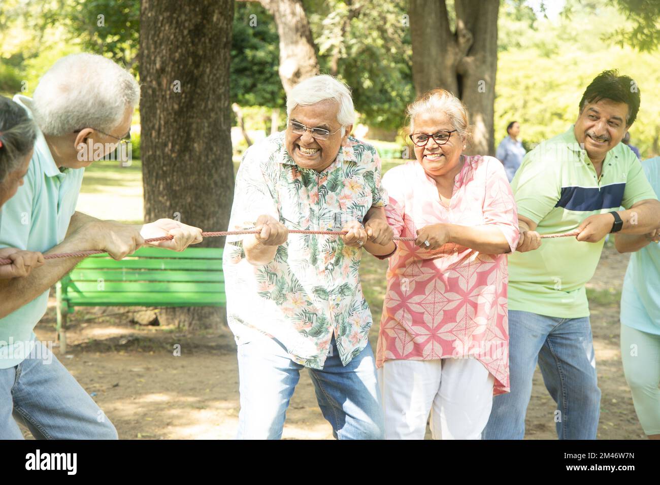 Group Of Senior Indian People Playing Tug War Outdoor In Park. Retirement life. Stock Photo