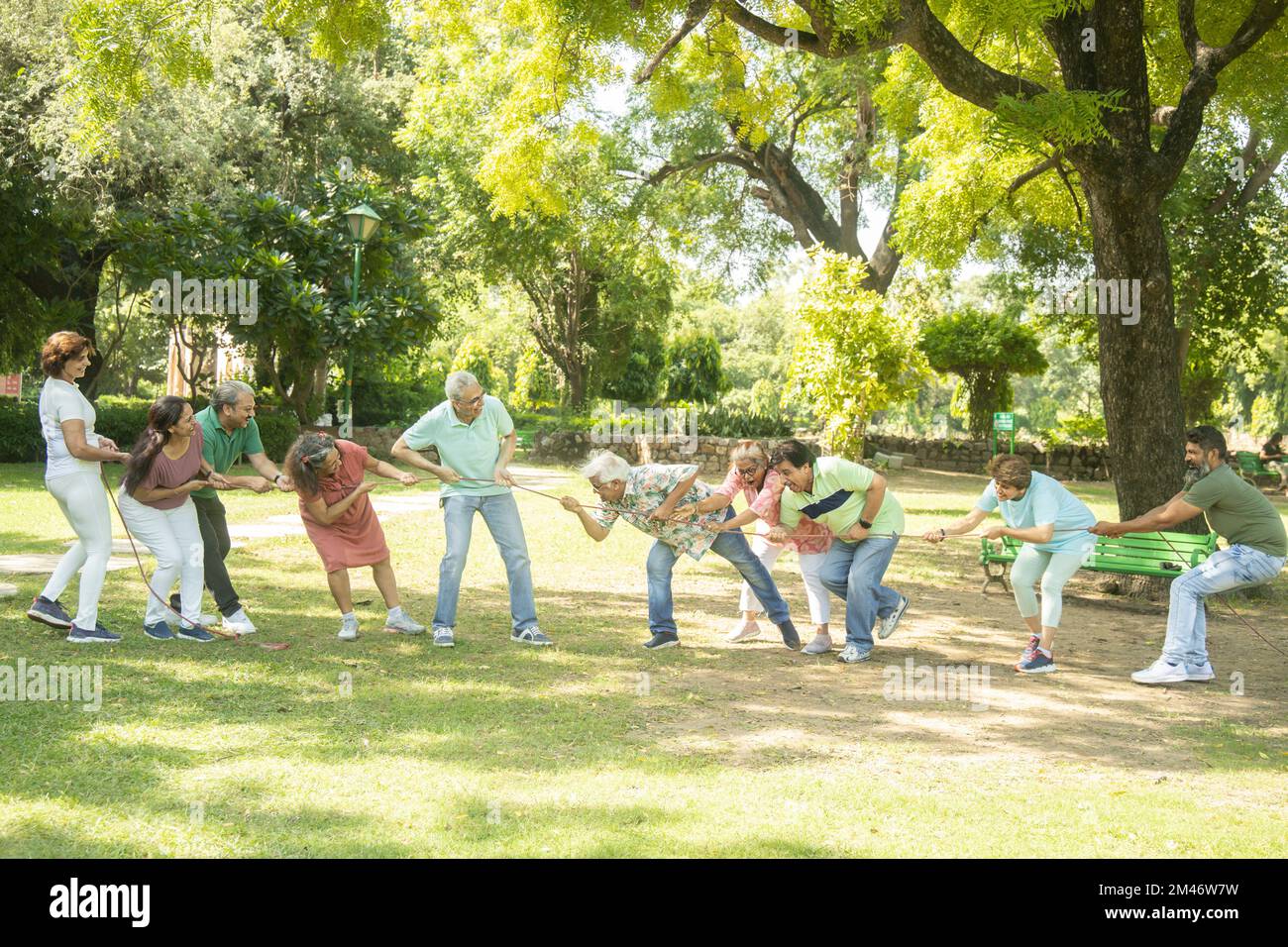 Group Of Senior Indian People Playing Tug War Outdoor In Park. Retirement life. Stock Photo