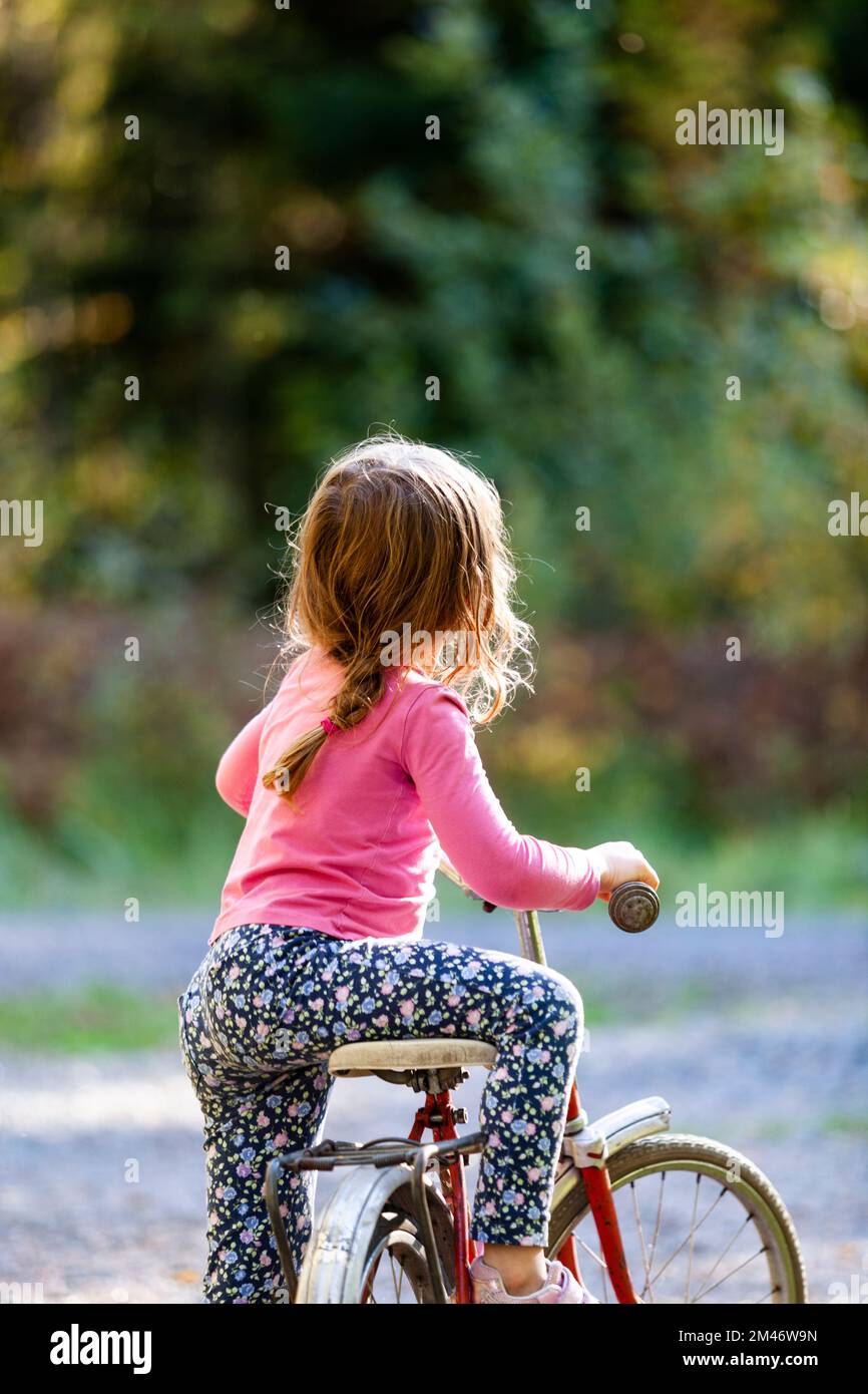 Girl on old-fashioned bicycle Stock Photo