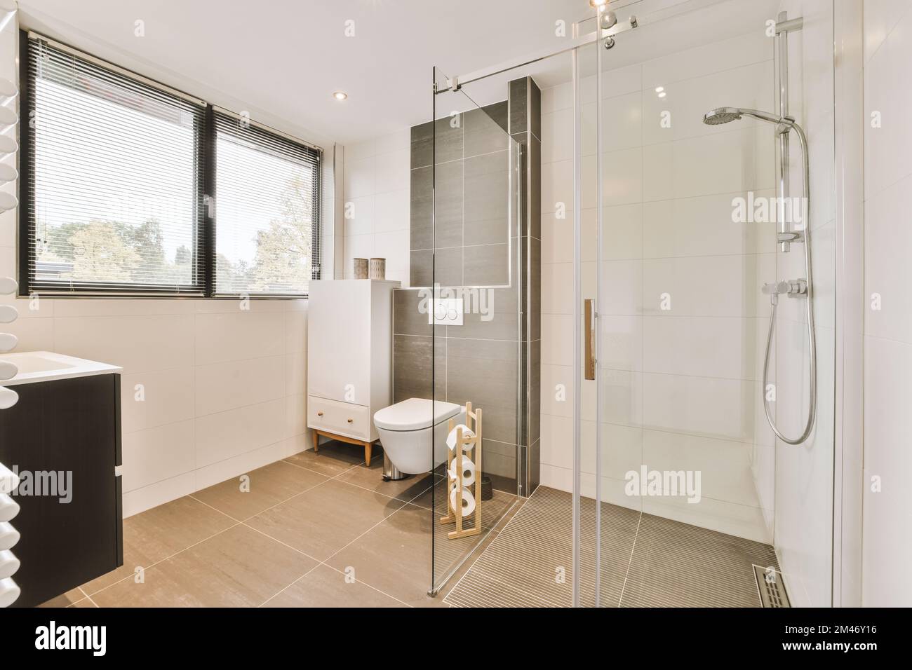 a bathroom with a toilet, sink and shower stall in the same room on the
