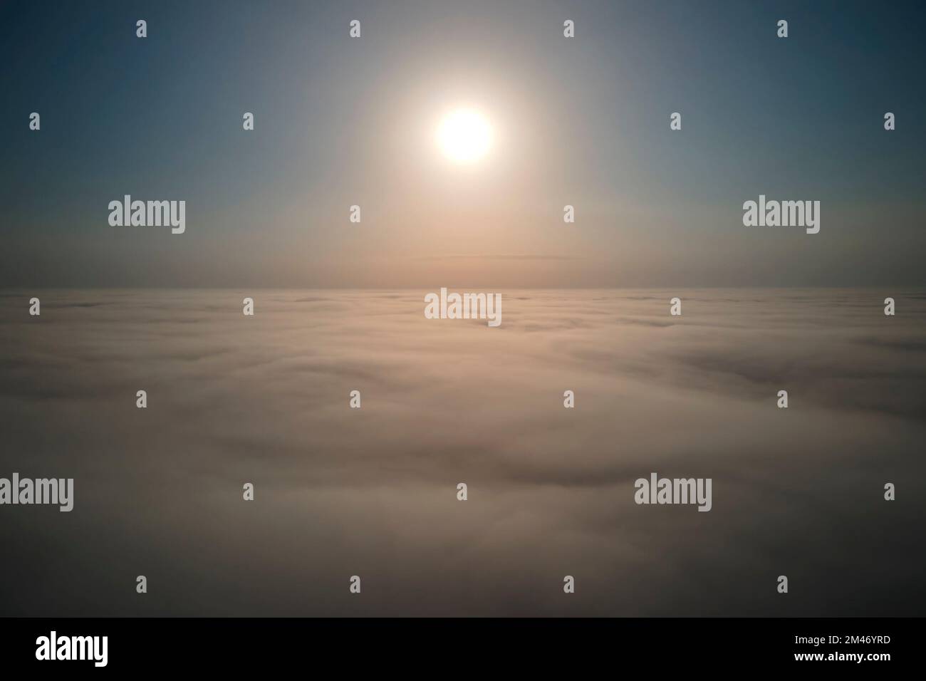 Aerial view from above at high altitude of dense puffy cumulus clouds ...