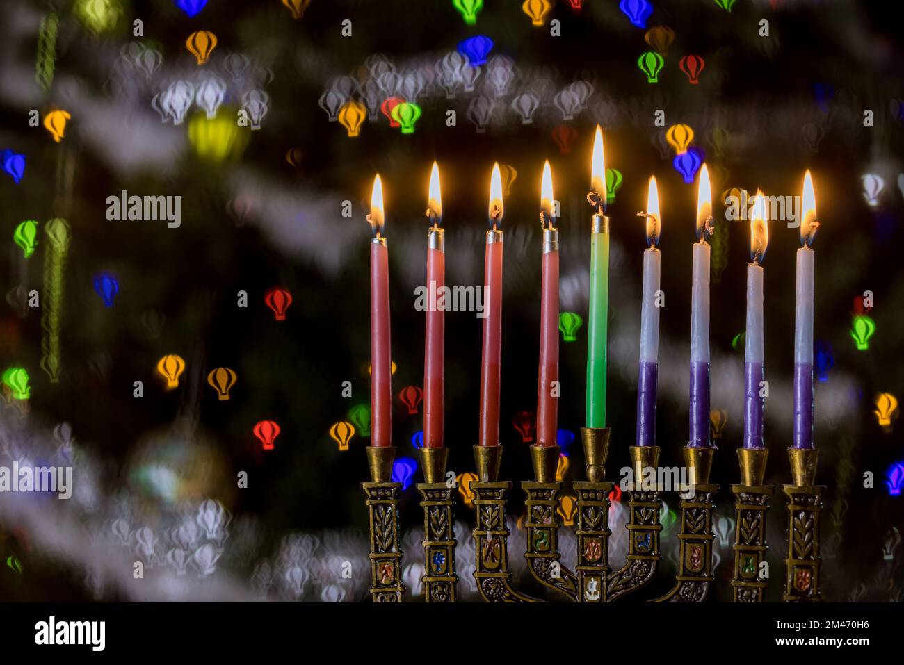 Colorful candles from a burning hanukkah candles in a menorah Selective soft focus Stock Photo