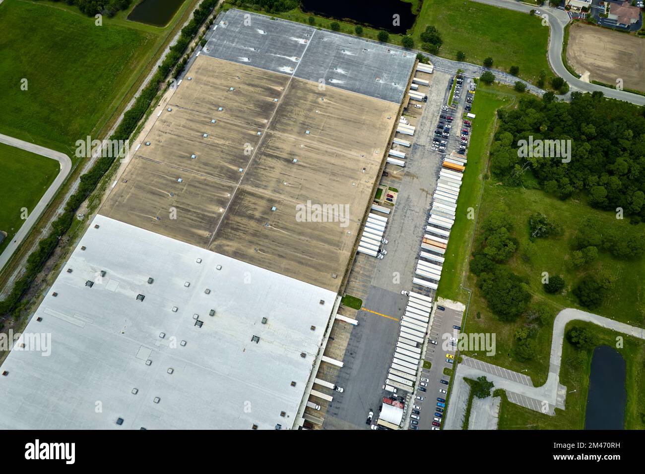 Aerial view of large commercial loading bay with many delivery trucks