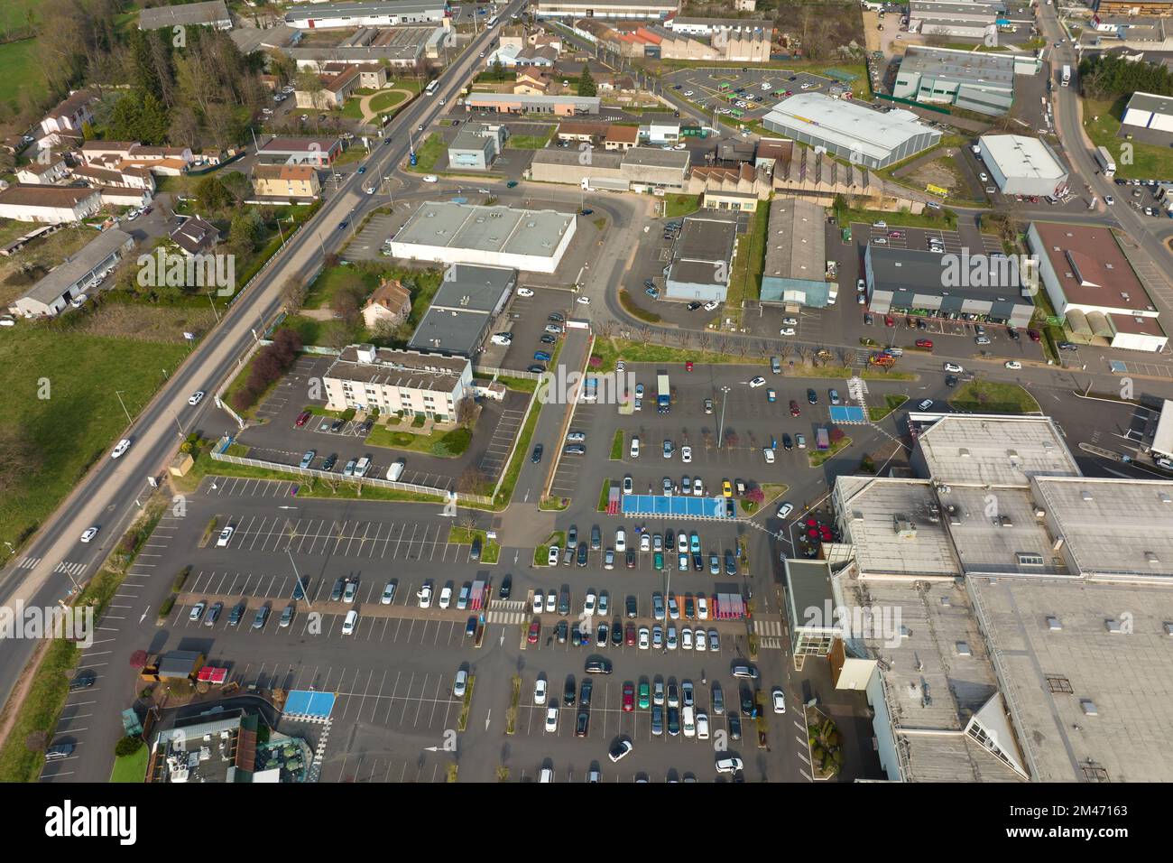Aerial view of many colorful cars parked on parking lot with lines and