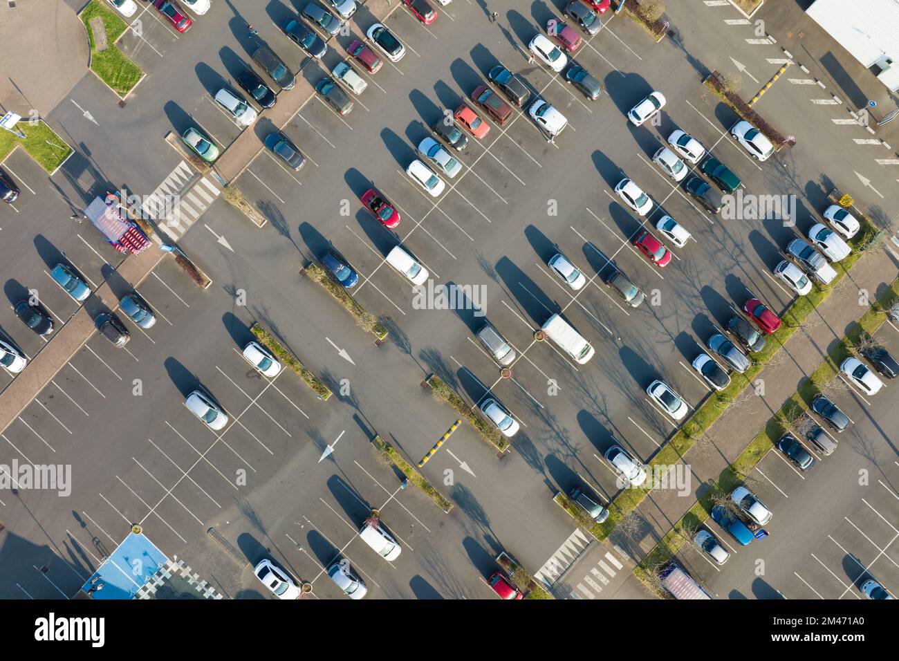 Aerial view of many colorful cars parked on parking lot with lines and