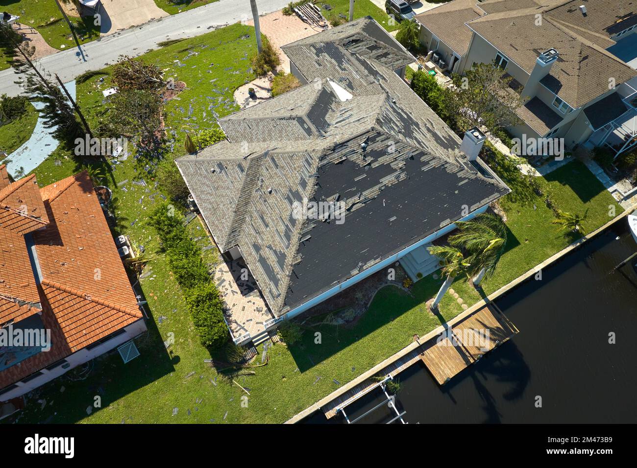 Hurricane Ian destroyed house roof in Florida residential area. Natural ...
