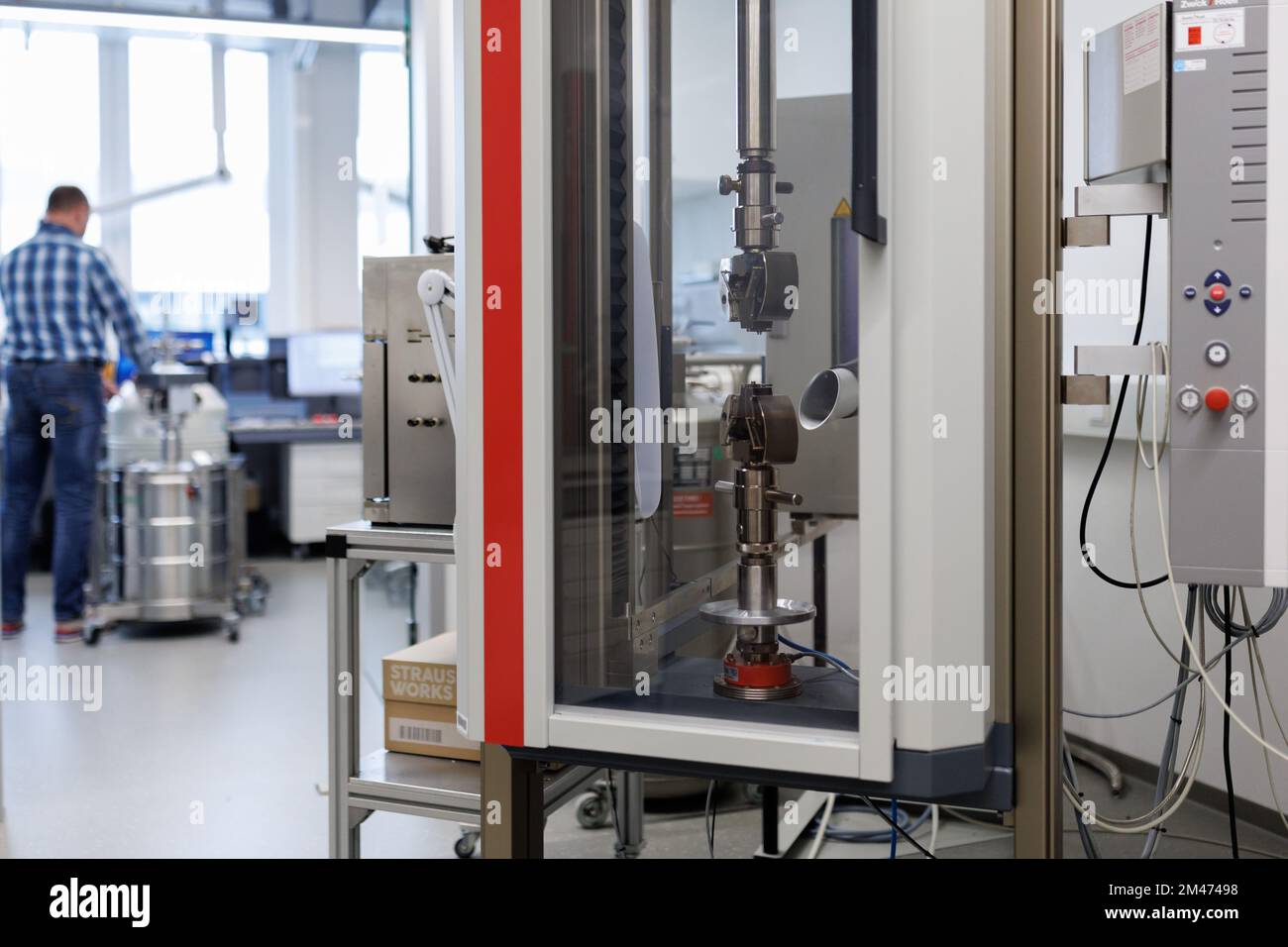 19 December 2022, Bavaria, Erlangen: A tensile testing machine, for determining material properties such as modulus of elasticity and tensile strength, stands in a Siemens AG laboratory in the research and laboratory building on the new Siemens Campus Erlangen as part of the official opening of the campus. The technology corporation Siemens has unveiled one of the largest construction projects in its company history at its Erlangen location. The new Siemens Campus, an open urban district with 540,000 square meters of space, will soon be home to 17,000 employees of Siemens and Siemens Energy. P Stock Photo