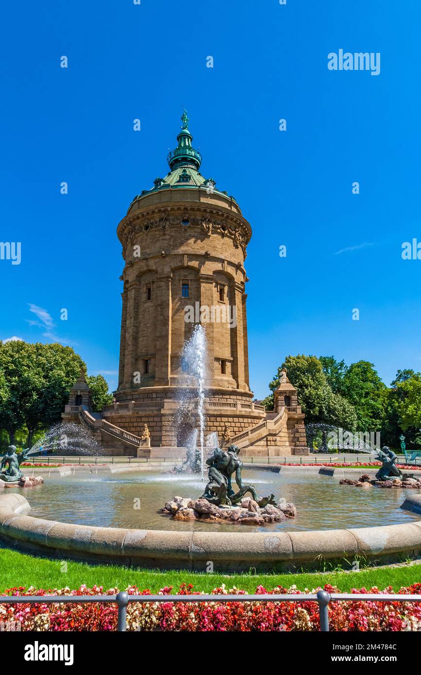 Lovely view of the famous Water Tower (Wasserturm) and the fountain with water spouts in front on a sunny day with blue sky in Mannheim, Germany. On... Stock Photo
