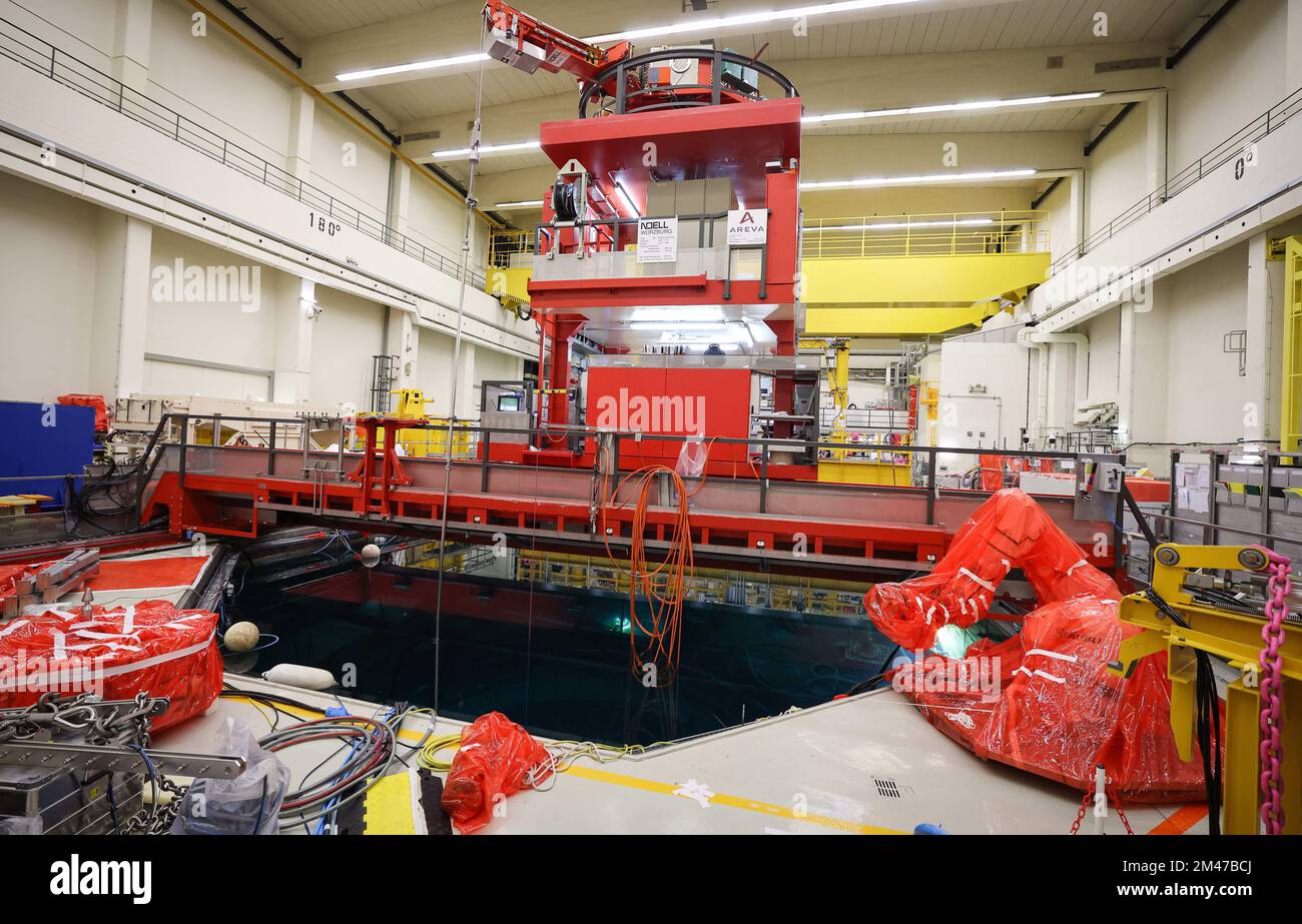 19 December 2022, Schleswig-Holstein, Brunsbüttel: The covered cutting robot 'Azuro' (automatic dismantling of RPV internals using underwater robot technology, r) stands next to the decay basin and the loading platform during a press tour of the Brunsbüttel nuclear power plant (KKB). The dismantling of the Brunsbüttel nuclear power plant in Schleswig-Holstein is making progress. The reactor has been permanently shut down since 2007, with dismantling starting in 2019. Photo: Christian Charisius/dpa Stock Photo