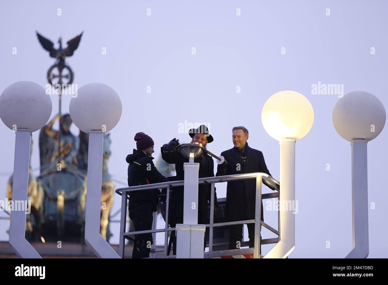 (12/18/2022) Berlin: Hanukkah at the Brandenburg Gate - inauguration and ceremony. The lighting of the first Hanukkah candle.The photo shows Federal Finance Minister Christian Lindner and Yehuda Teichtal, Rabbi of the Jewish Community in Berlin, lighting the first Hanukkah candle at the Brandenburg Gate. (Photo by Simone Kuhlmey/Pacific Press/Sipa USA) Stock Photo