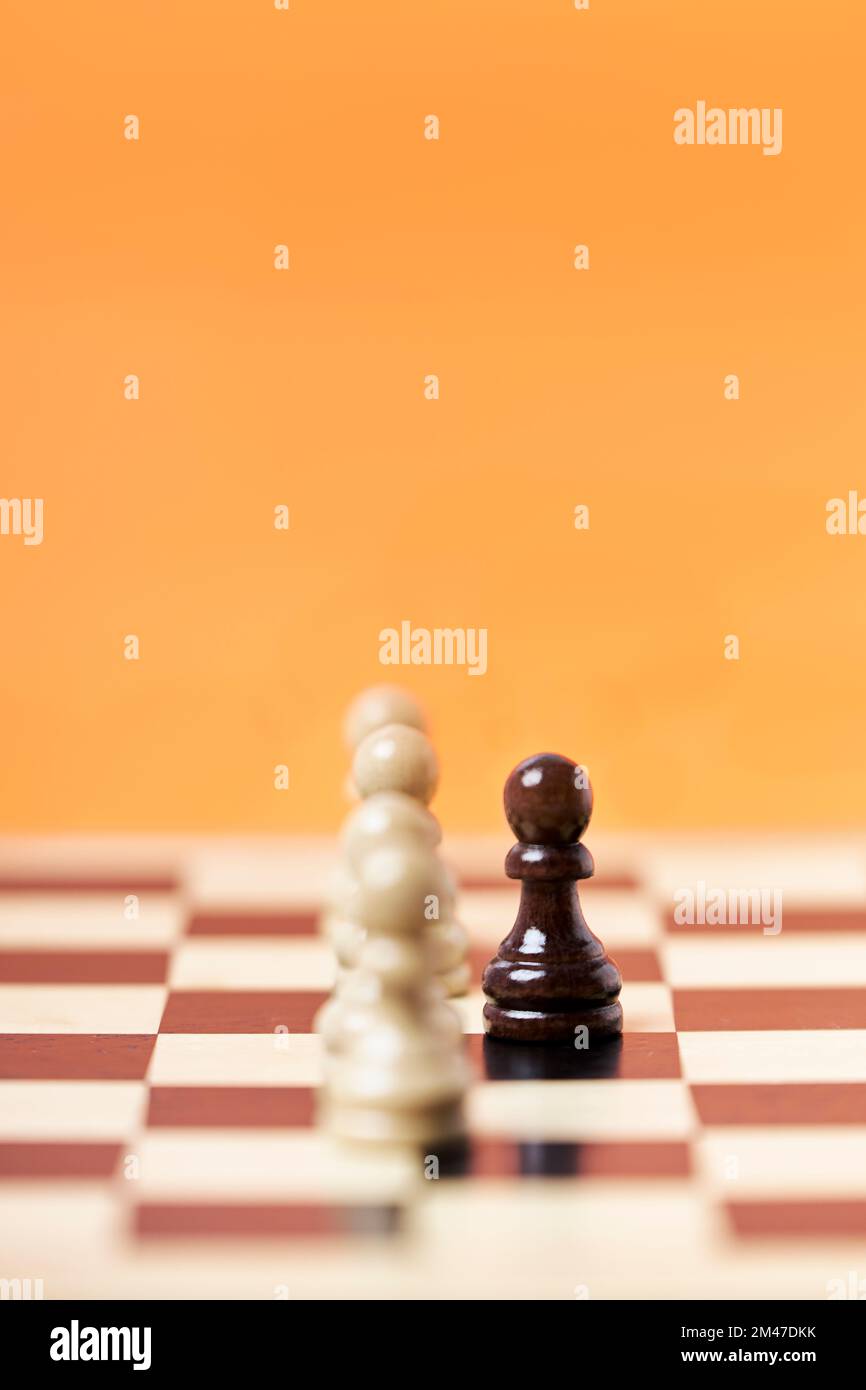 Chess row of white pawns with black pawn challenge center. Chess game strategy Stock Photo