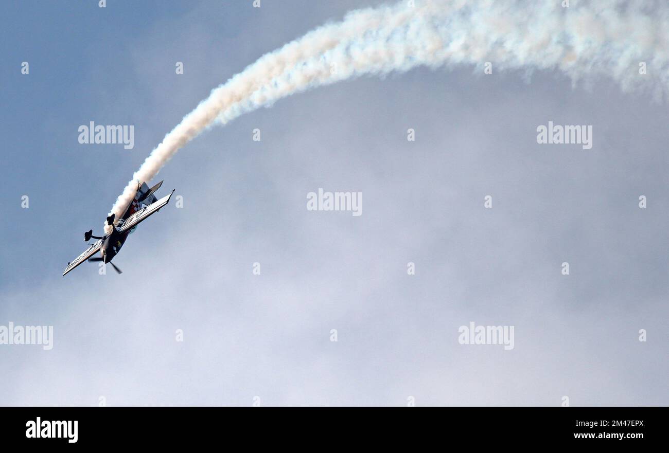 A stunt plane flying upside down. Stunts or aerobatics. Stock Photo