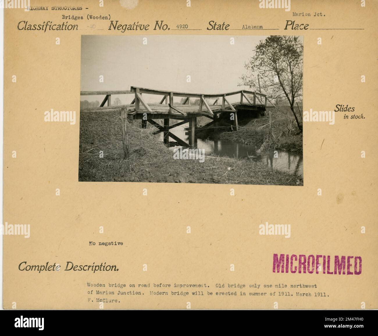 Wooden bridge on road before improvement. Original caption Old bridge