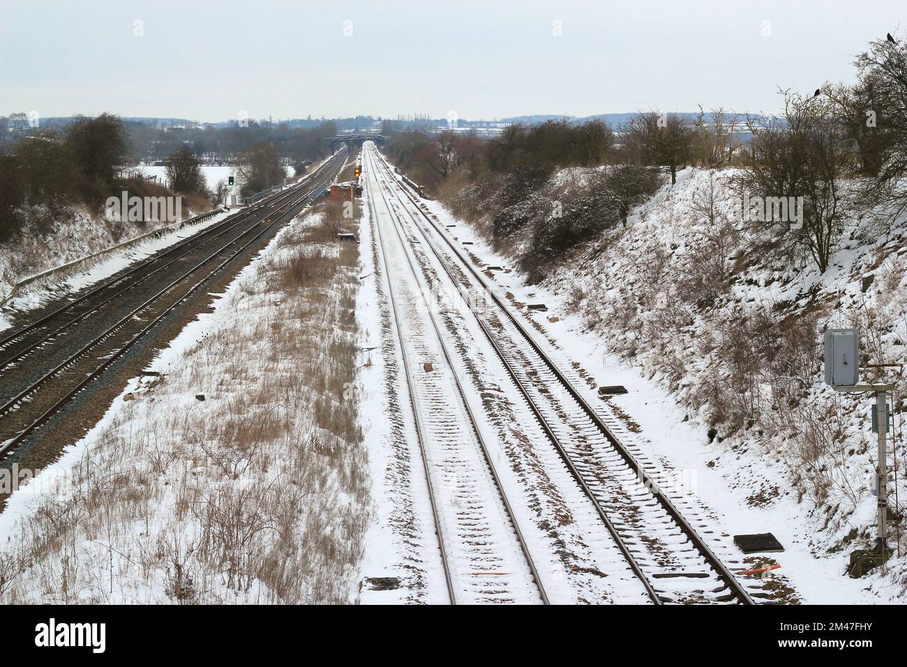 Straight railway tracks in the snow. Tracks seen from above. Stock Photo