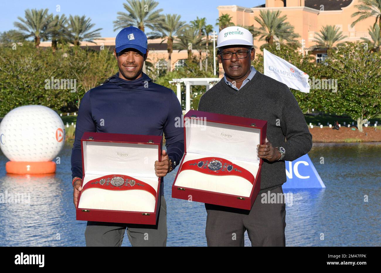 Qass Singh (L) and Vijay Singh pose with the trophies after winning the