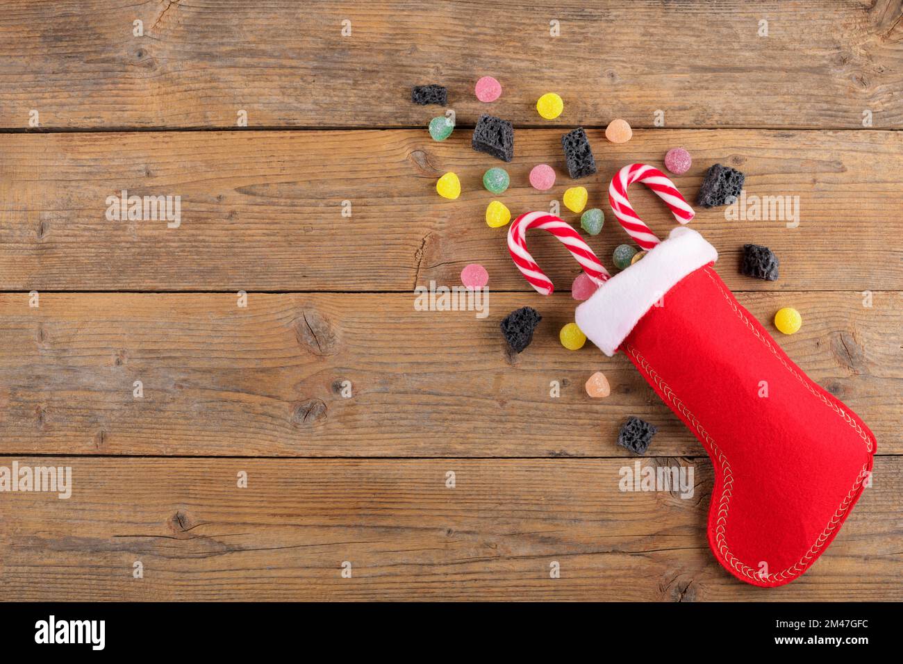 The Befana sock with sweet coal and candy on wooden background. Italian  Epiphany day tradition Stock Photo - Alamy