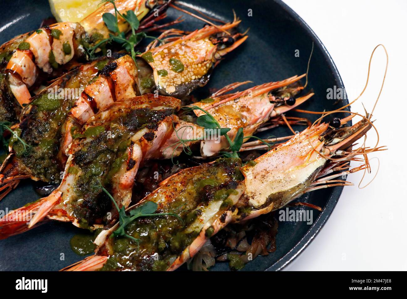 spice marinated grilled king tiger prawns or shrimps in a plate with