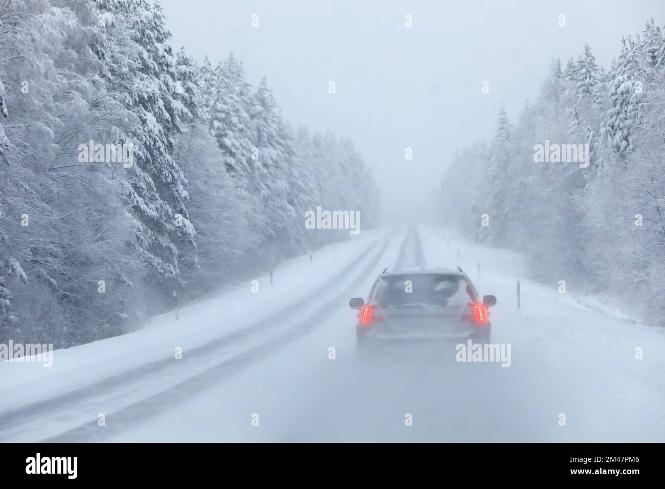 Cars in heavy snowstorm with weak visibility Stock Photo