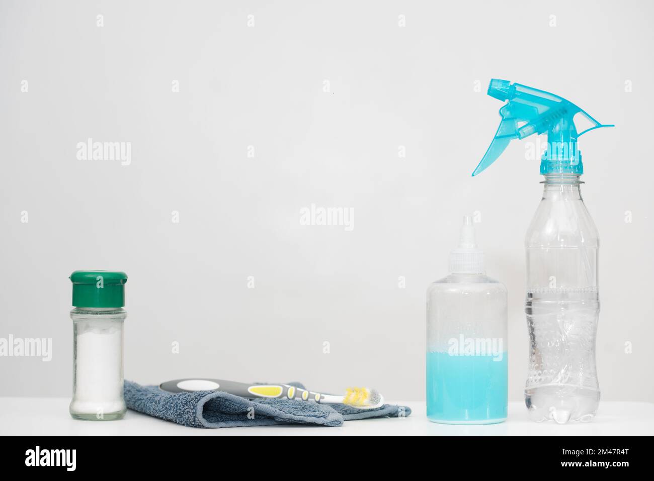 Home cleaning products in reused plastic bottles. Recycled household materials on white background. Horizontal copy space. Save the earth concept. Stock Photo
