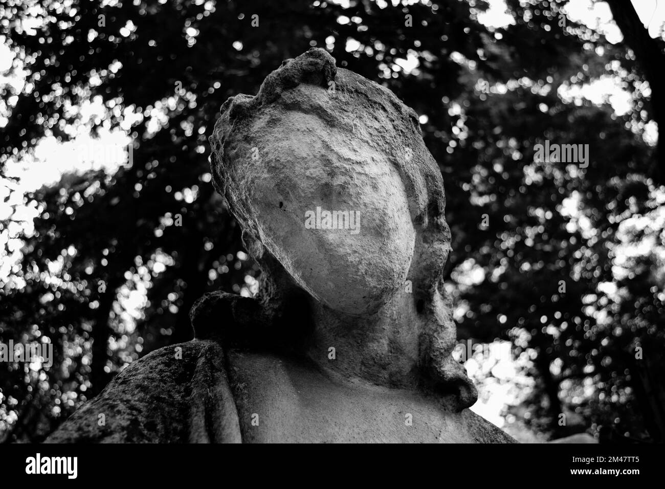 A ruined statue in an old graveyard in grayscale Stock Photo Alamy