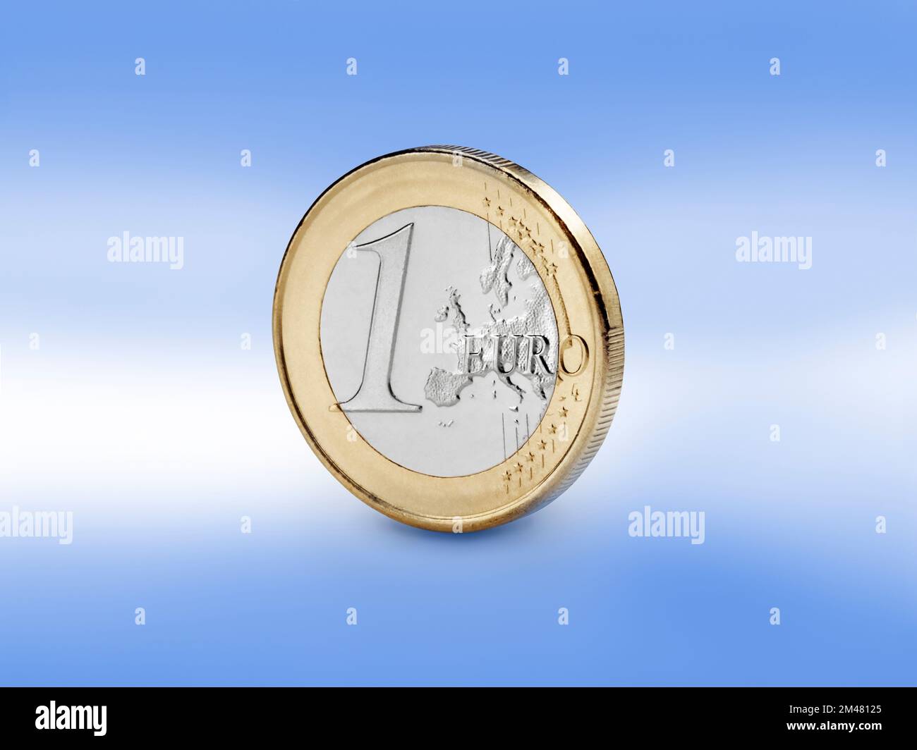 Closeup view of Euro coin against european blue color background. Stock Photo