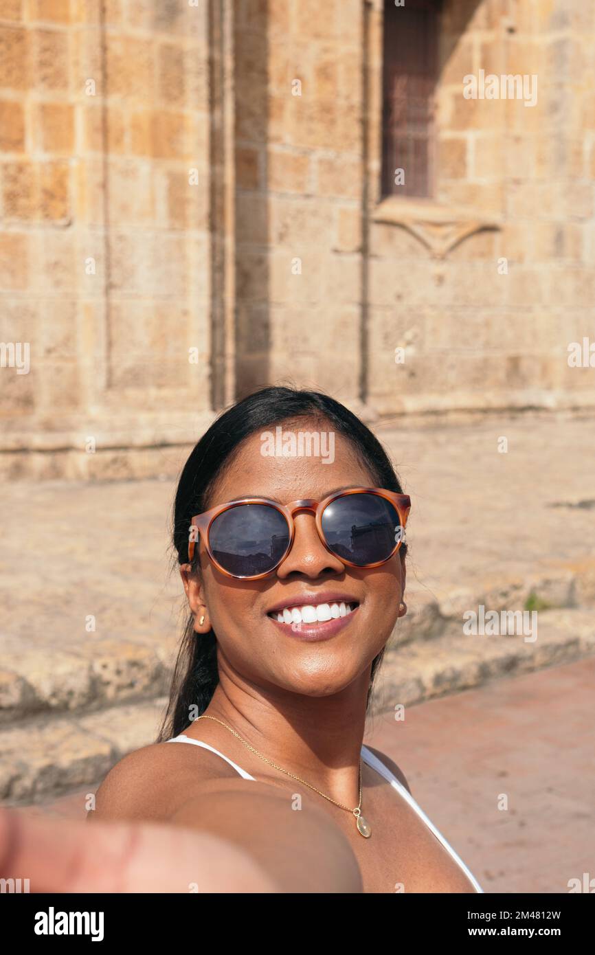 Young woman in Cartagena, Colombia taking a selfie with the city in the  background Stock Photo - Alamy, image size:866x1390