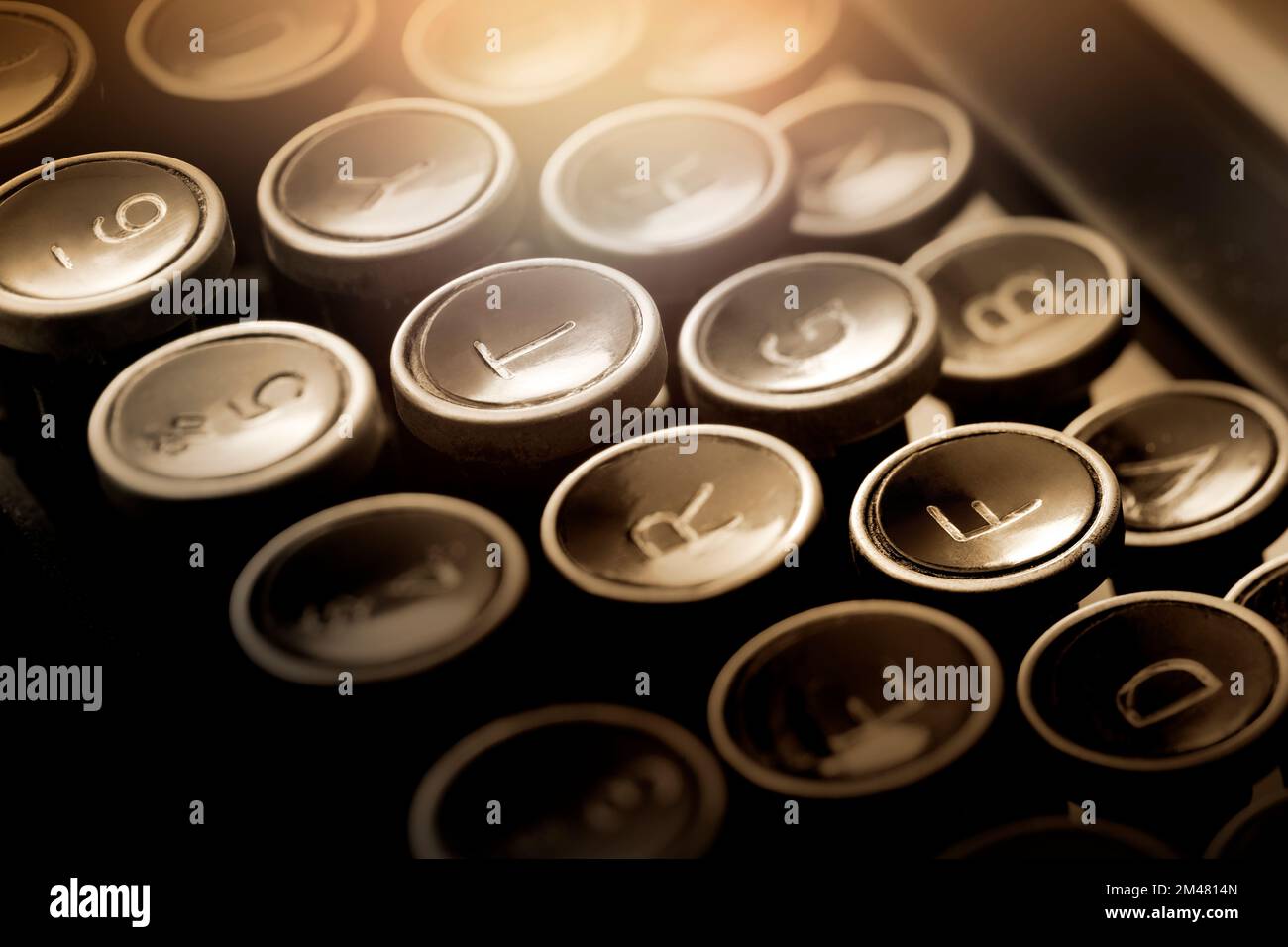 Shallow focus on close up view of ancient types keys. Warm light effect to give intimate ambience. Stock Photo