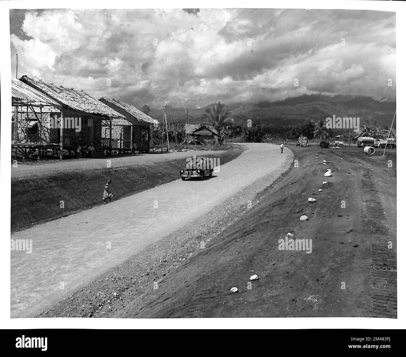 Completed Section Kidapawan - Calauag Road. Original caption: Completed section Kidapawan - Calauag Road. 8.0 meter shoulder to shoulder subgrade. 6.0 meter select material surfacing. Taken by C. N. Aldrich. State: Philippines. Place: Cotabato. Stock Photo