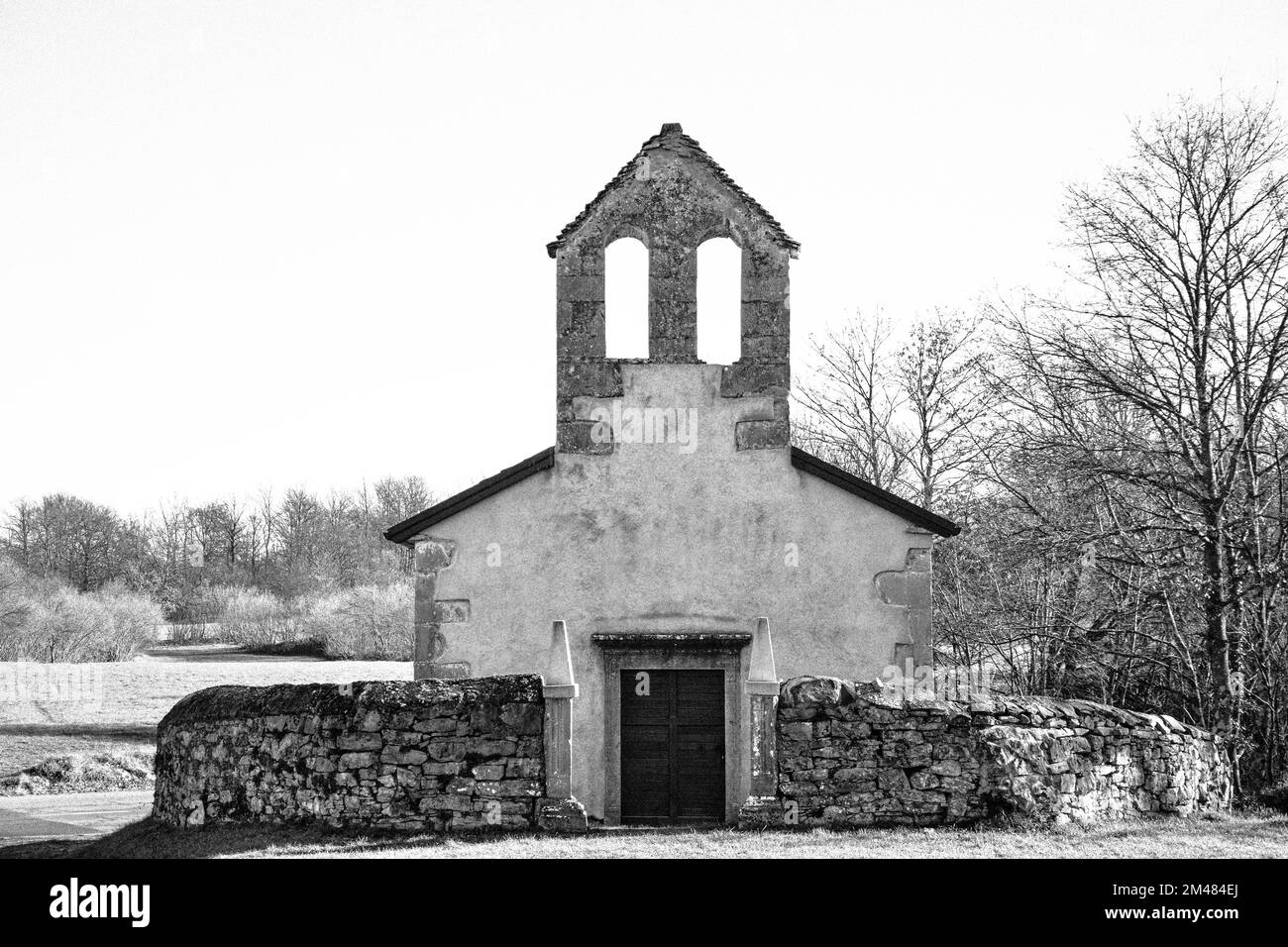 Black & white, monochrome photo of a medieval old stone church in Kras, Slovenia Stock Photo