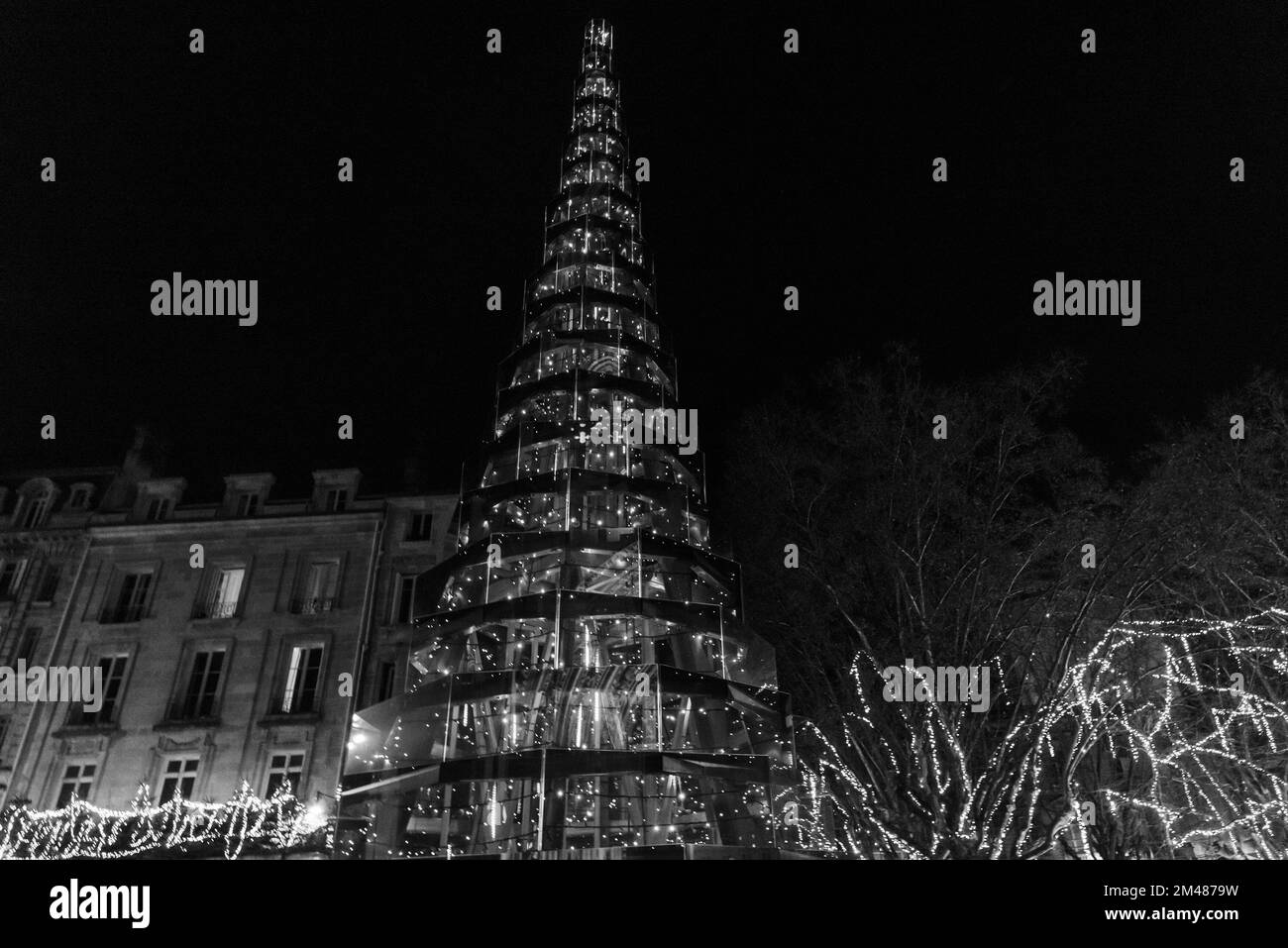 Christmas tree at the square in Bordeaux, France. Enchanted fairy tale night. Winter holidays celebration background. Black white historic photo Stock Photo