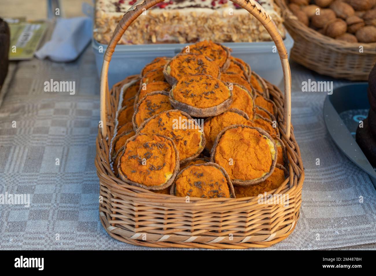A full wicker basket. Rye Latvian dessert Sklandrausis with carrot