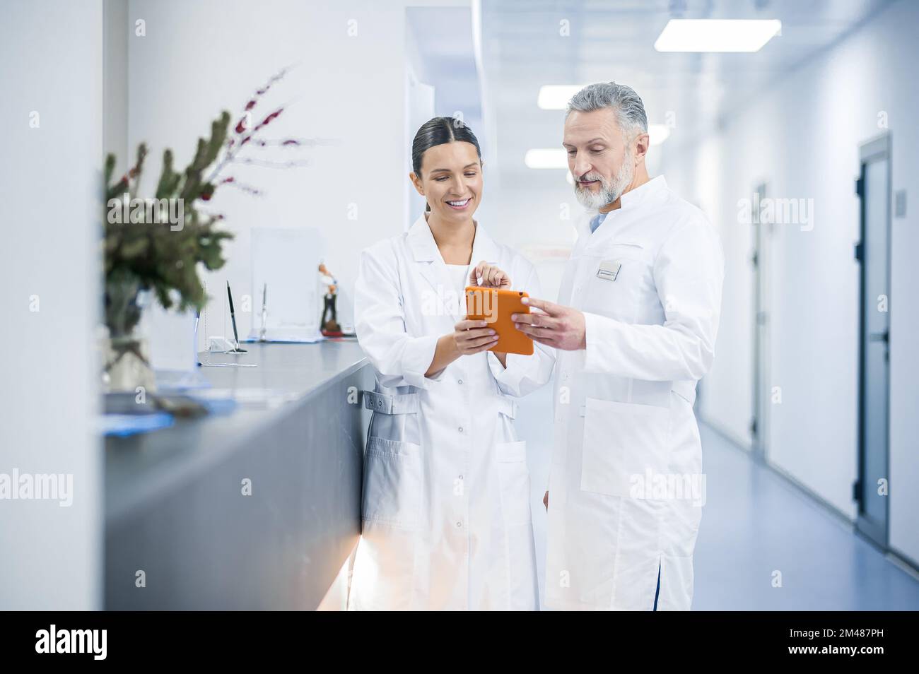 Two doctors talking in the hospital during the shift change Stock Photo