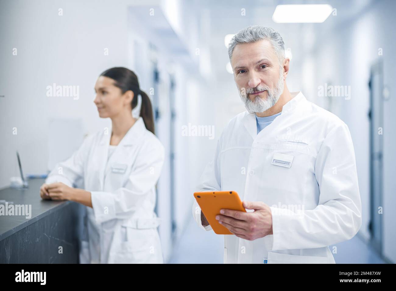 Two doctors talking in the hospital during the shift change Stock Photo
