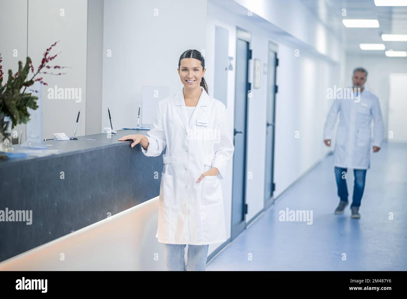 Doctors in lab coats in the clinic corridor Stock Photo