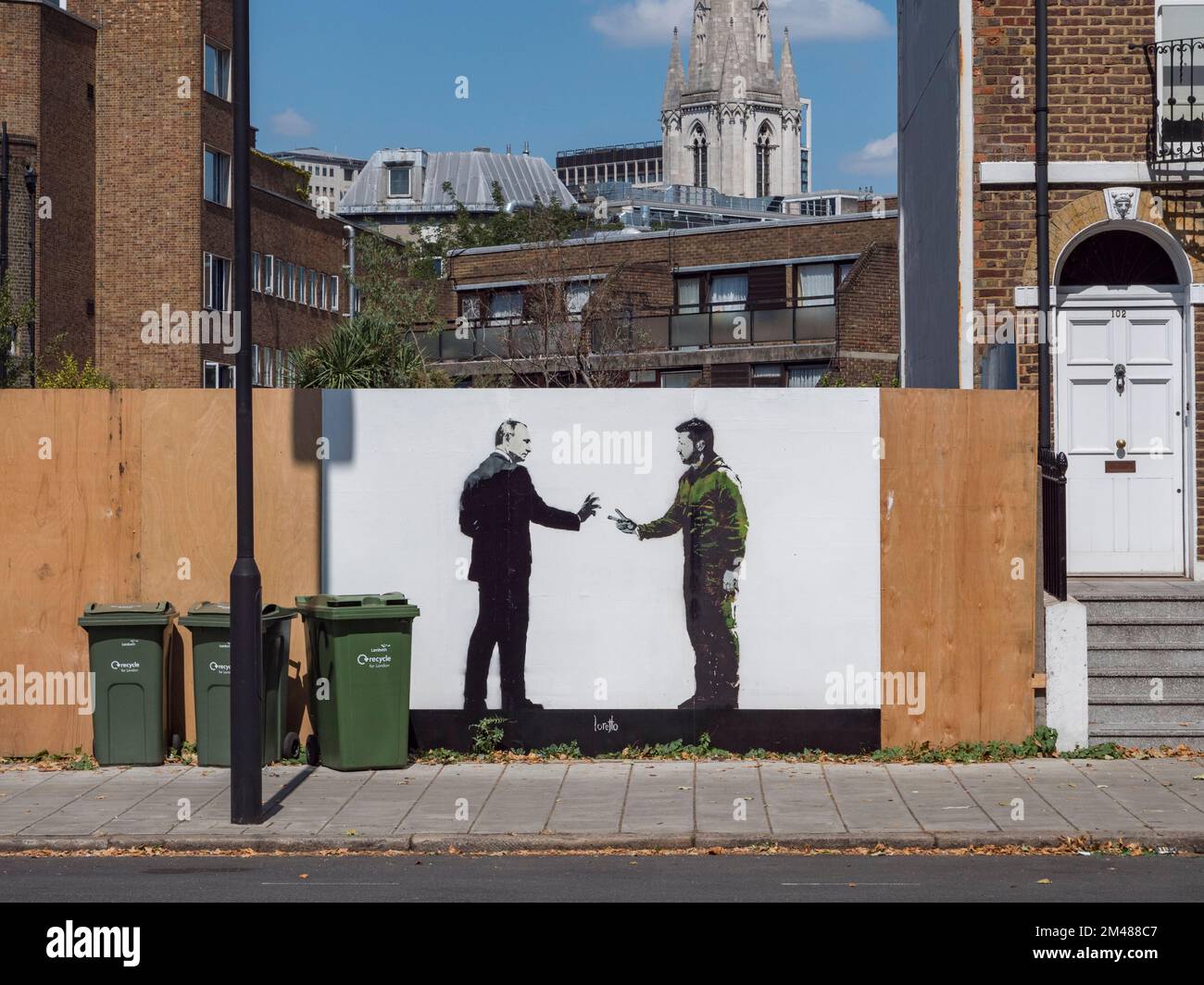 Street art by Loretto showing Vladimer Putin attempting to shake hands with a two-finger saluting Volodymyr Zelenskyy, Lambeth, London, UK. Stock Photo