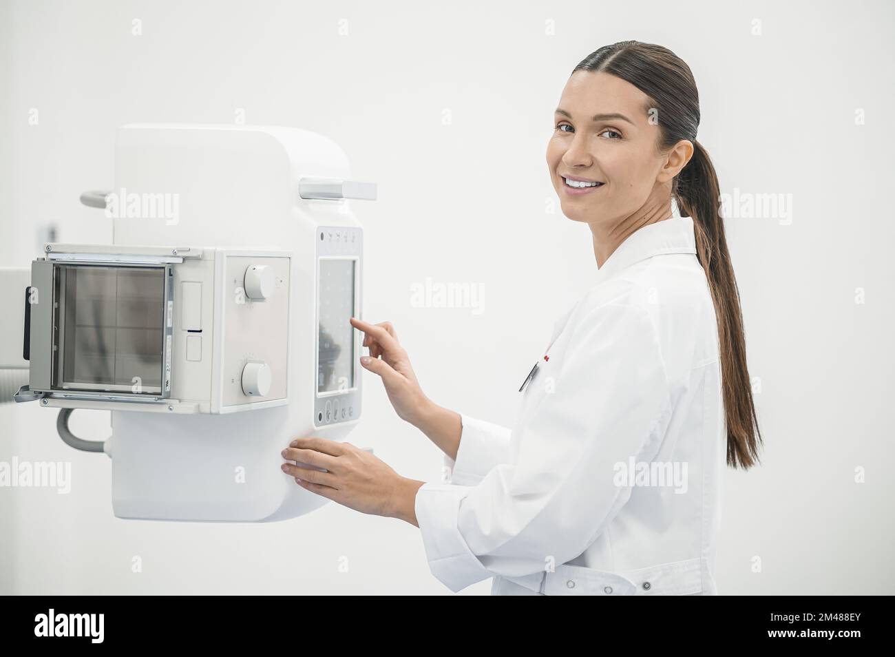 Pretty young female doctor dealing with the medical equipment Stock Photo
