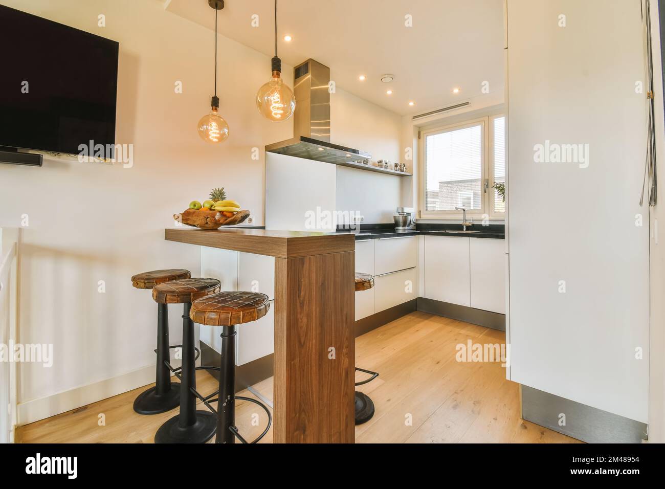 a kitchen and dining area in a small apartment with white walls