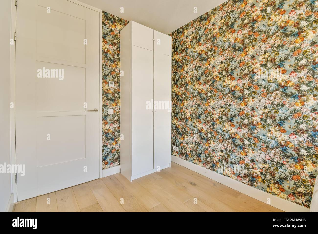 an empty room with floral wallpaper on the walls and wooden flooring in ...