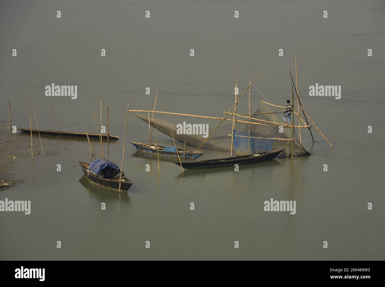 Guwahati, Guwahati, India. 19th Dec, 2022. A fisherman spread his fishing net in river
